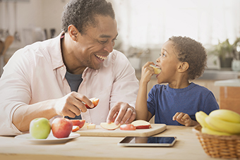 Dad and son eating apples
