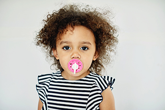 Toddler girl with a pacifier