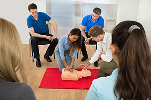 High school students learning CPR