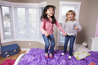 Girls jumping on a bed