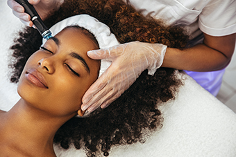 Teen girl getting laser facial treatment